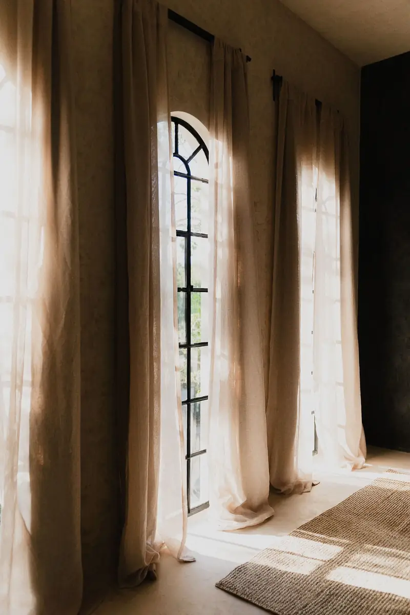 Altar — arched windows and linen curtains